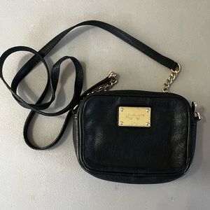 Small black cross body bag from micheal kors with gold accents and chain